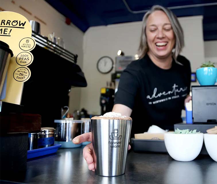 Owner Enna Grazier pours an iced mocha made from house made small batch chocolate with flight espresso and steamed milk at Enna Chocolate in Exeter.